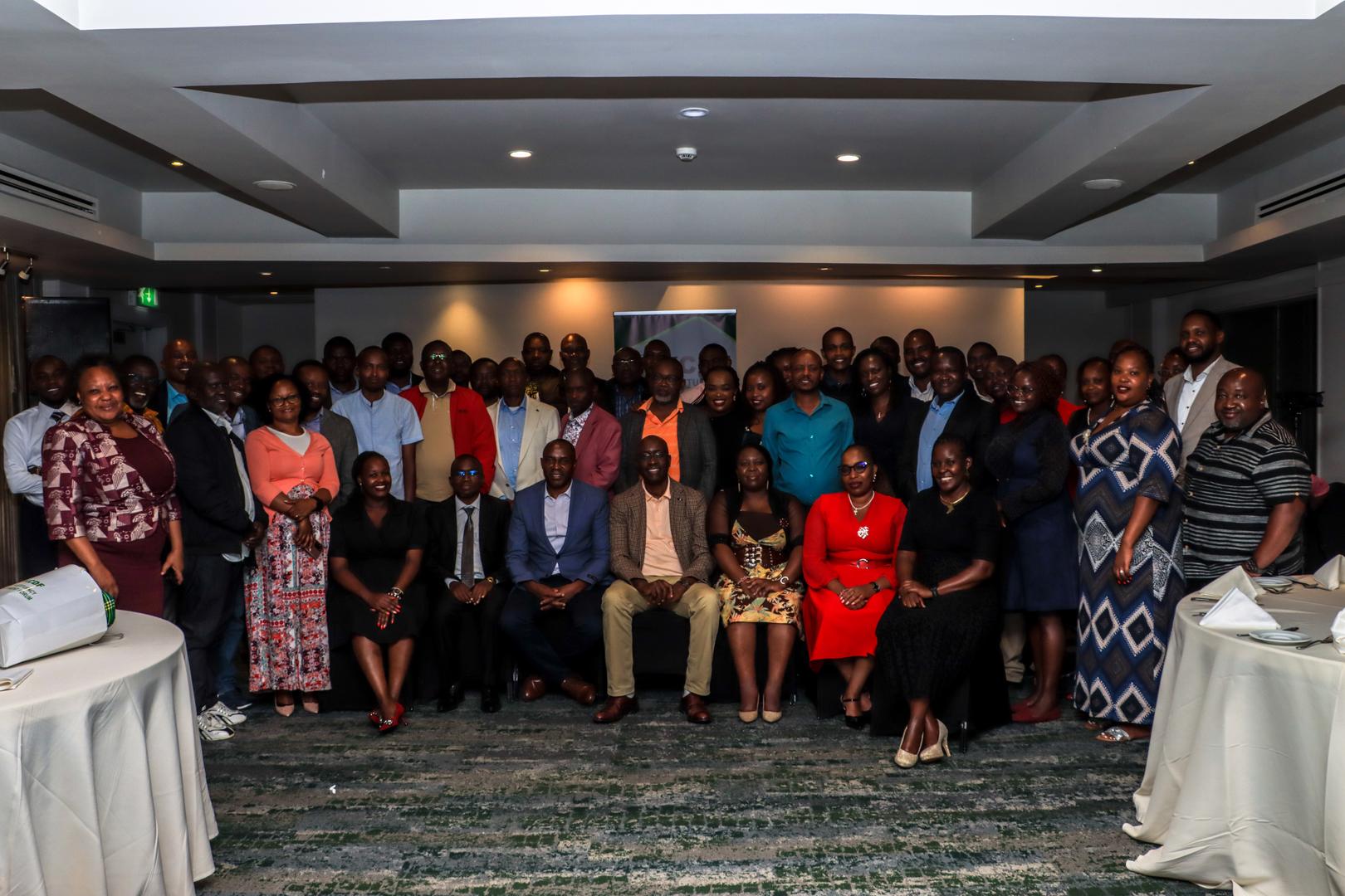 Community members gathered together indoors in the original MCDF group photograph